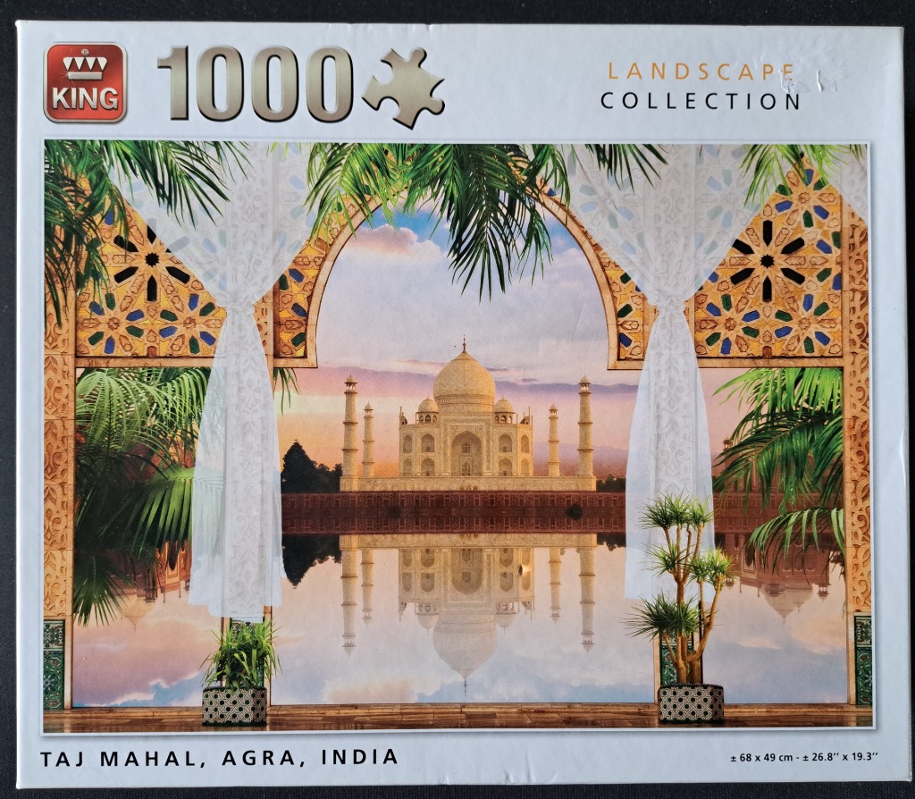 The Taj Mahal viewed through a grand archway draped with sheer white curtains and framed by tropical palm leaves.