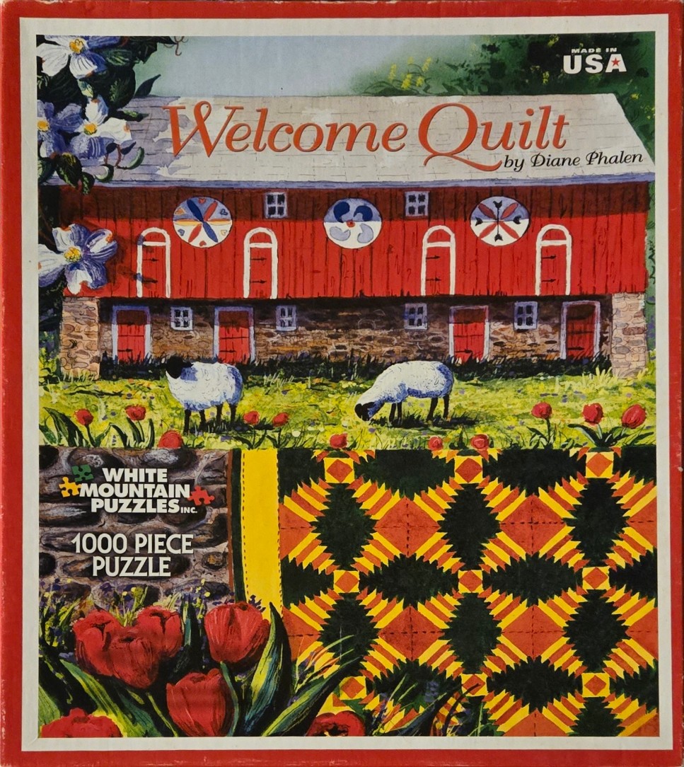 A pastoral painting of a red barn with quilt patterns, grazing sheep, and a foreground quilt.