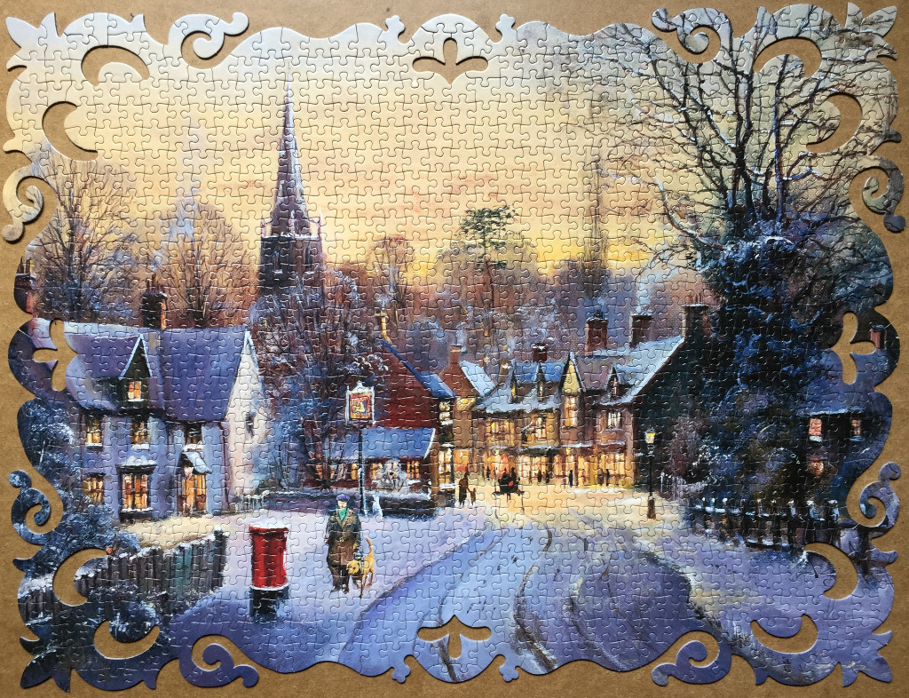 A snowy winter village scene at dusk with a church spire, cozy cottages, and a person walking a dog.