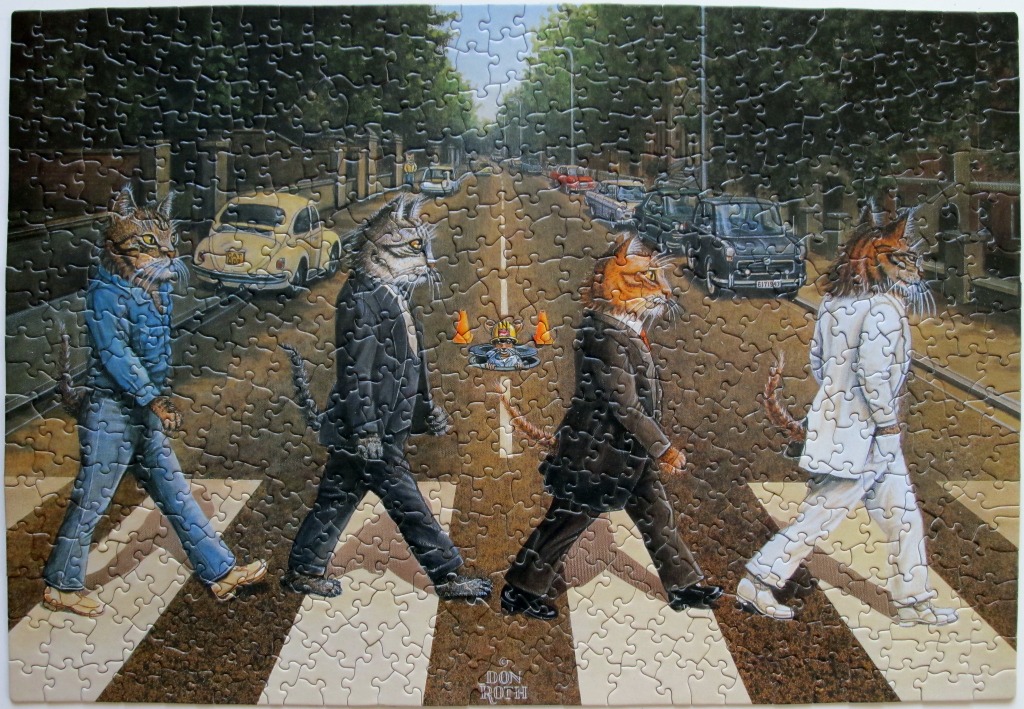 Four cats anthropomorphized to resemble the Beatles crossing Abbey Road in a whimsical illustration.