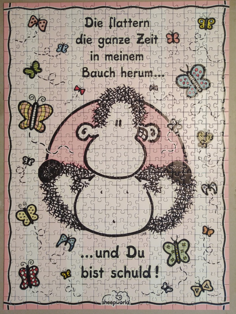 A cartoon sheep surrounded by butterflies with German text about butterflies in the stomach.