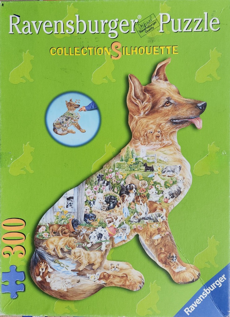 A large silhouette of a dog filled with a collage of many different breeds of puppies and dogs playing in a garden.