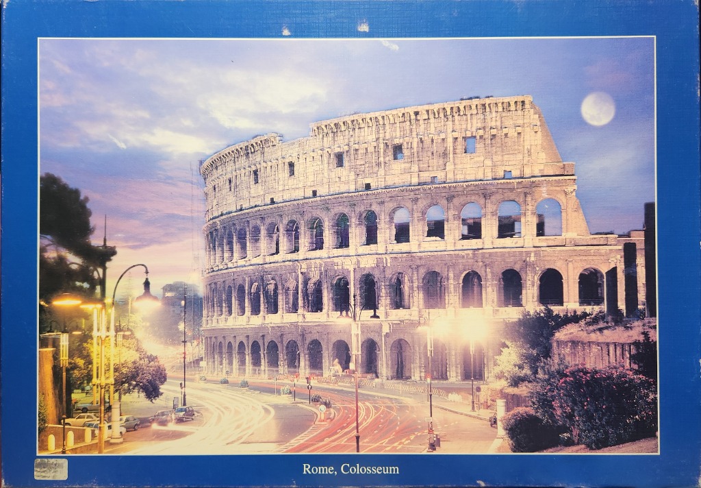 The Colosseum in Rome at twilight with long-exposure light trails on the road