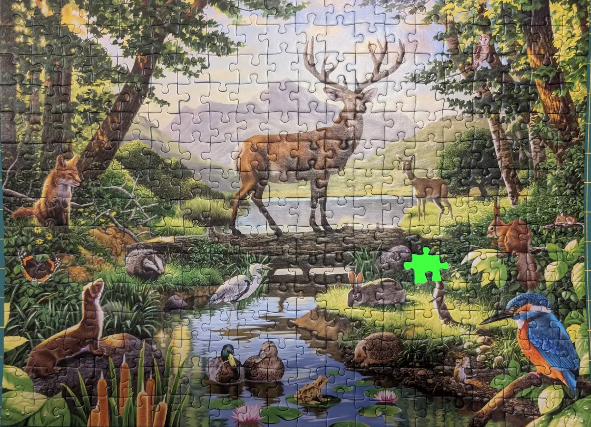A vibrant woodland scene featuring a large stag, numerous forest animals, and a tranquil stream.