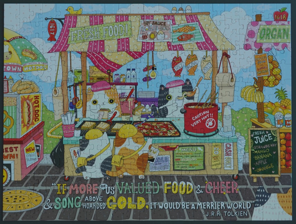 Cartoon illustration of cats running a food stall with a J.R.R. Tolkien quote at the bottom.