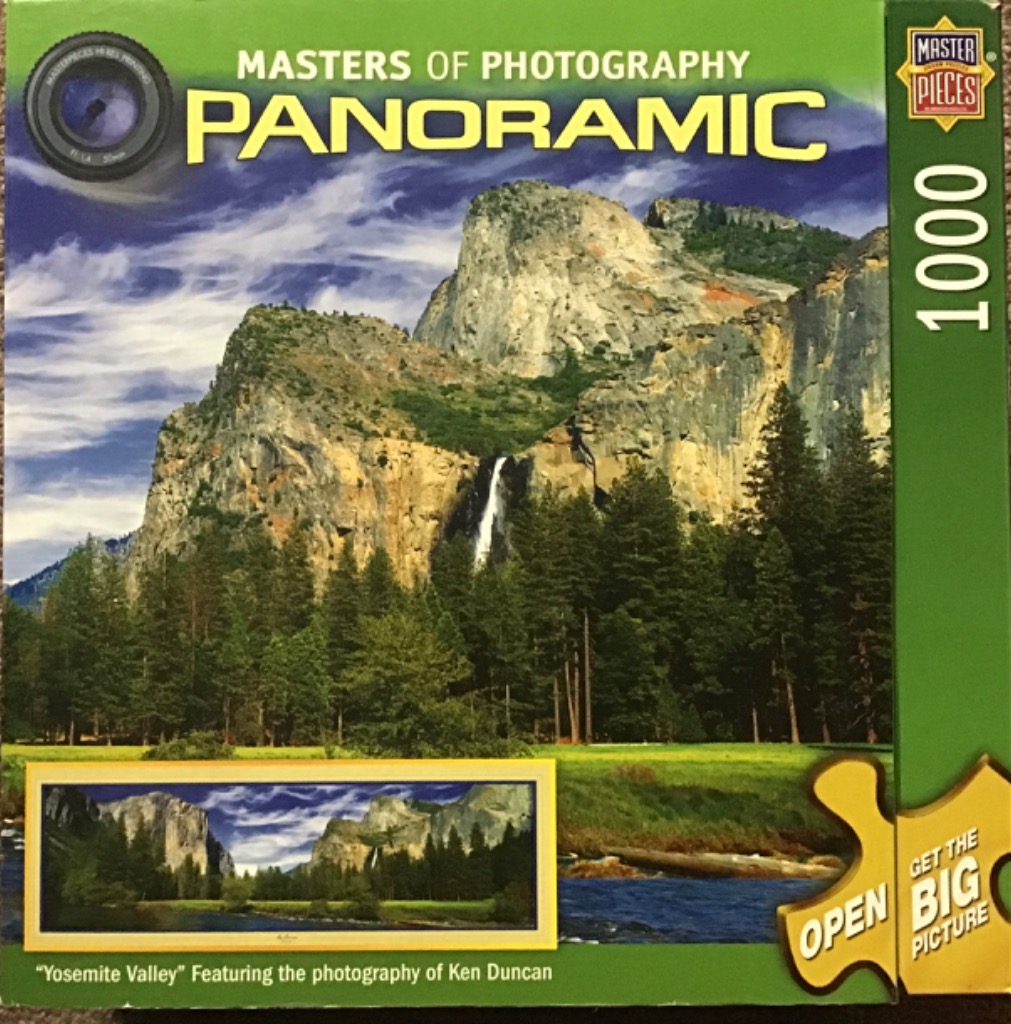 A panoramic landscape photograph of Yosemite Valley featuring granite cliffs, a waterfall, and dense pine forests.