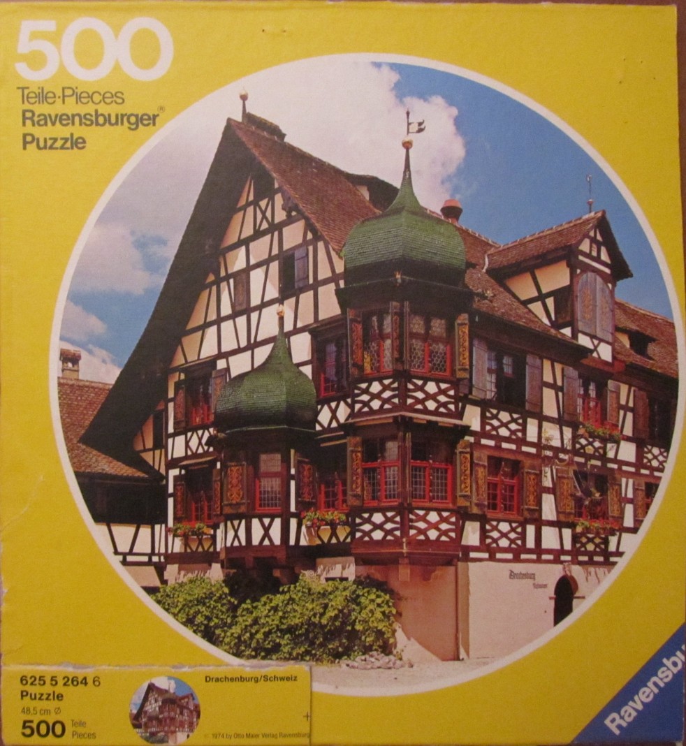 A low-angle view of a traditional timber-framed house with green turrets in Switzerland.