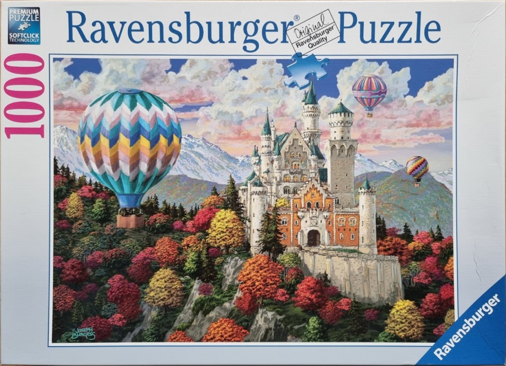 An illustration of a European-style castle set in an autumn forest with hot air balloons floating in the sky.
