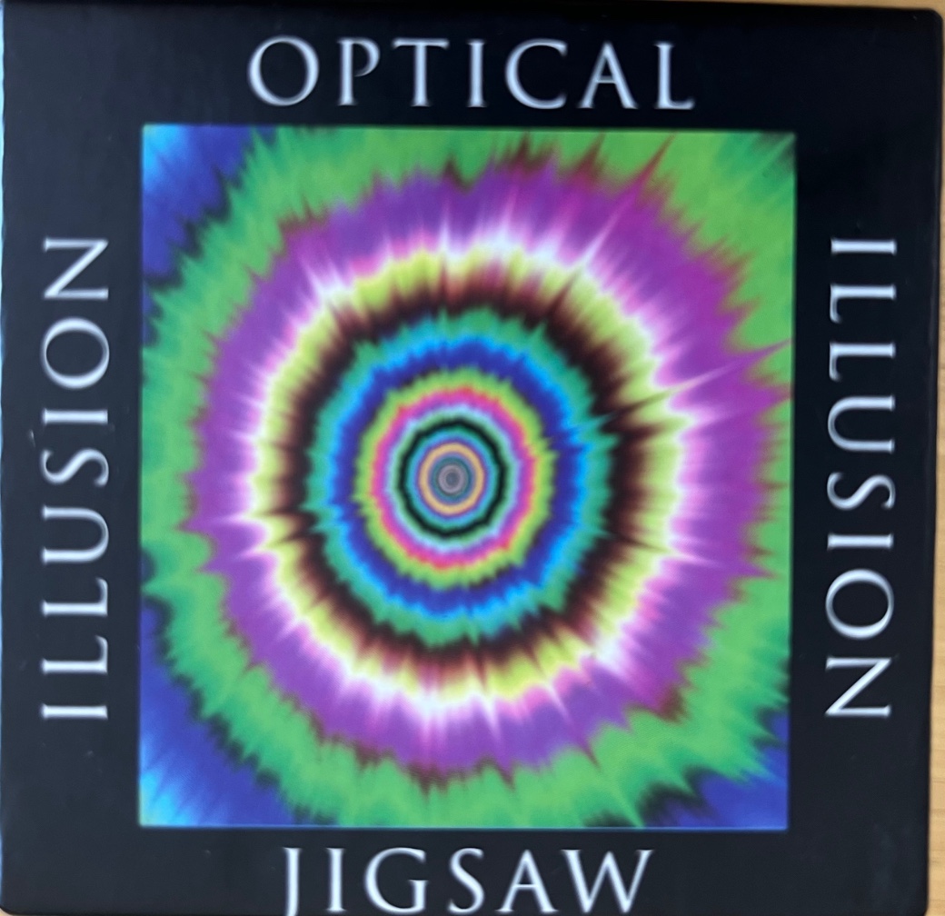 A psychedelic tie-dye style radial pattern with concentric rings of bright colors.