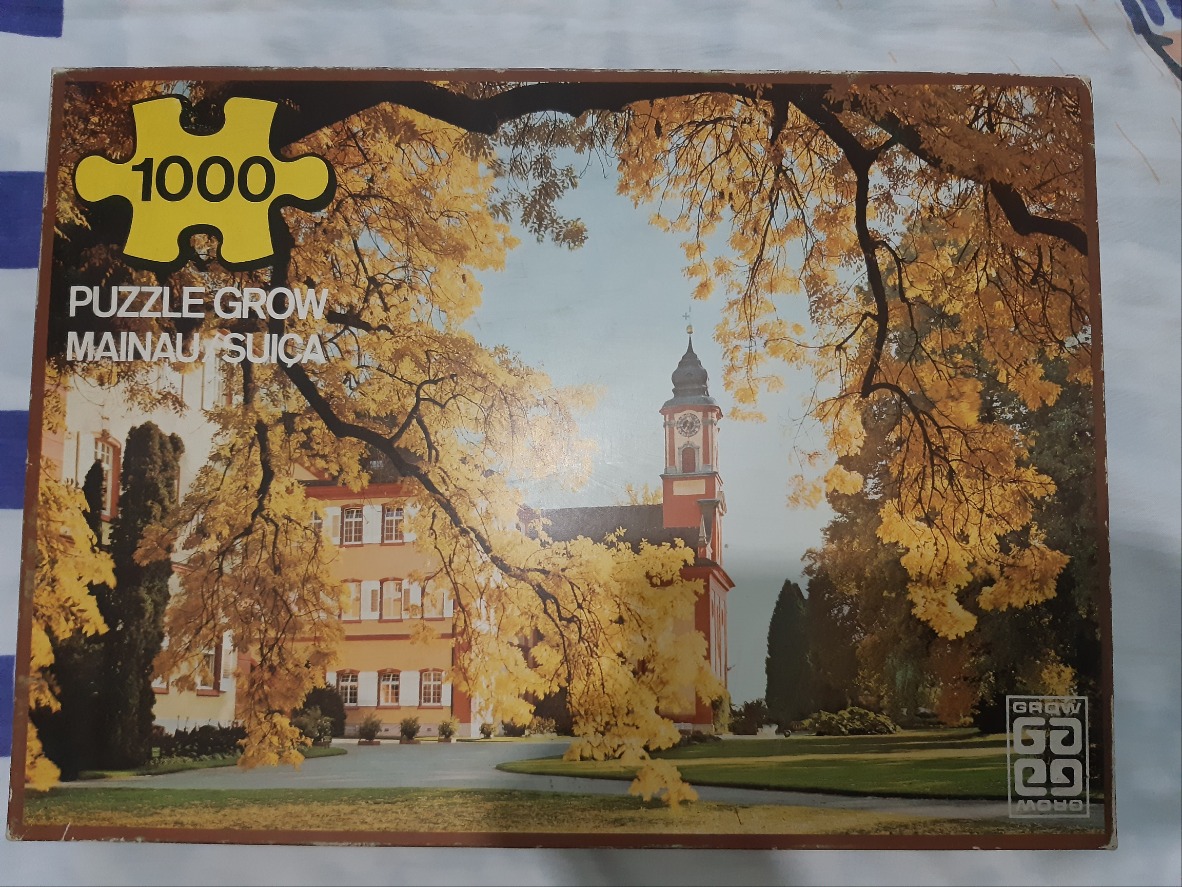Autumnal view of Mainau Palace and its tower framed by yellow leaves