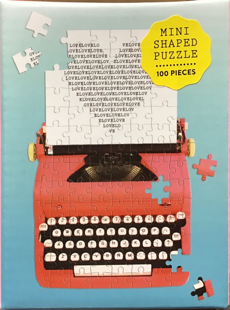 A vintage red typewriter with a page repeating the word LOVE sits on a light blue background.