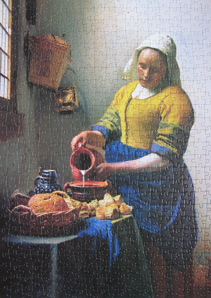 Painting of a kitchen maid pouring milk into a ceramic bowl on a table.