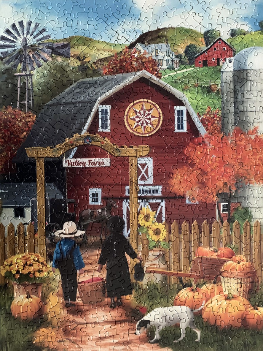A countryside scene featuring a red barn, pumpkins, and two children walking through a gate at Valley Farm.