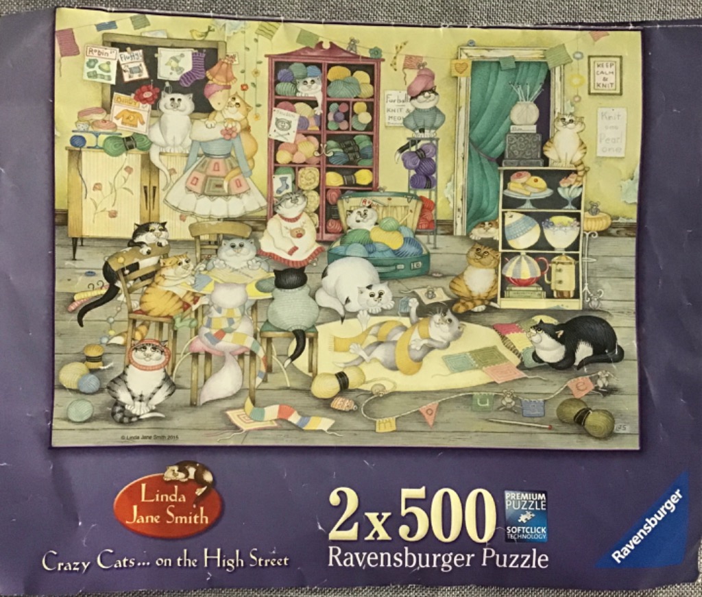 Illustration of numerous cats gathered in a cozy, yarn-filled craft room.