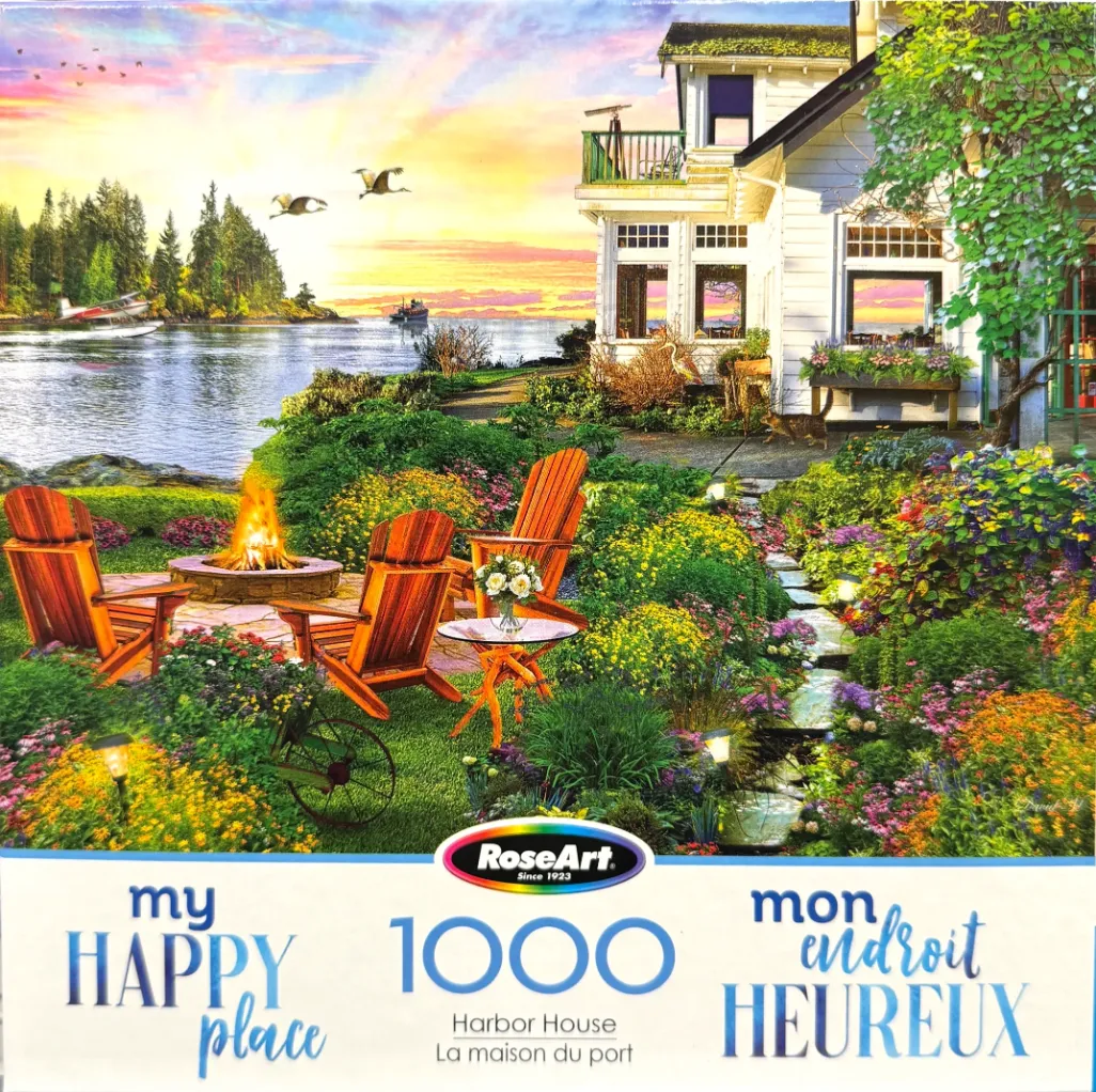 A serene lakeside garden at sunset featuring a fire pit, Adirondack chairs, and a white house with a telescope.