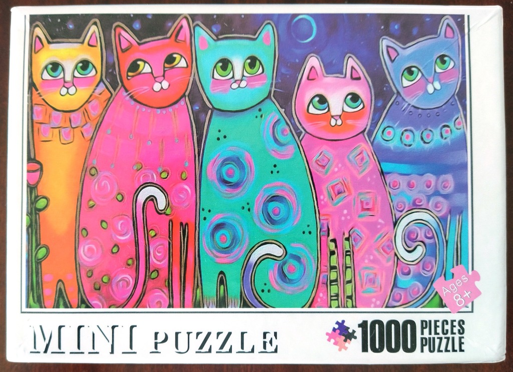 A whimsical illustration of five colorful, stylized cats standing in a row against a starry night sky.