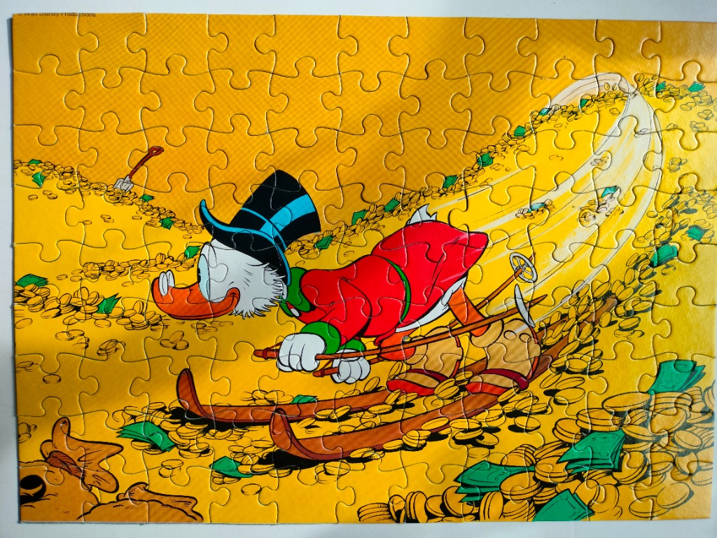 Scrooge McDuck skiing through a giant pile of gold coins