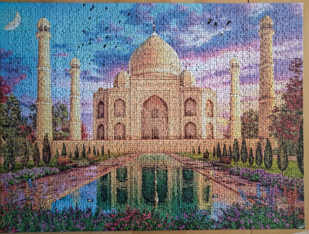 A scenic illustration of the Taj Mahal at sunset with a reflecting pool and garden in the foreground.