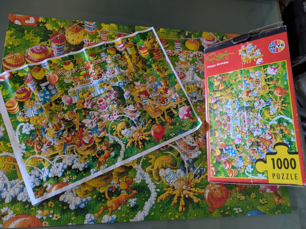 A chaotic, colorful cartoon illustration of an outdoor birthday party set in a lush green garden.