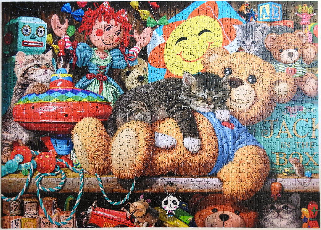 A whimsical collection of vintage toys and kittens arranged on shelves.