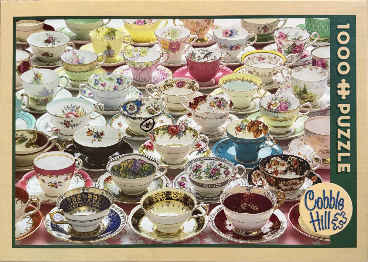 A collection of decorative vintage teacups and saucers arranged in a dense grid pattern.