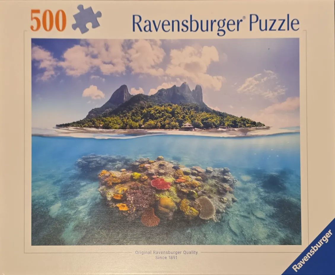 A split-level photograph showing a lush tropical island above water and a vibrant coral reef below the surface.