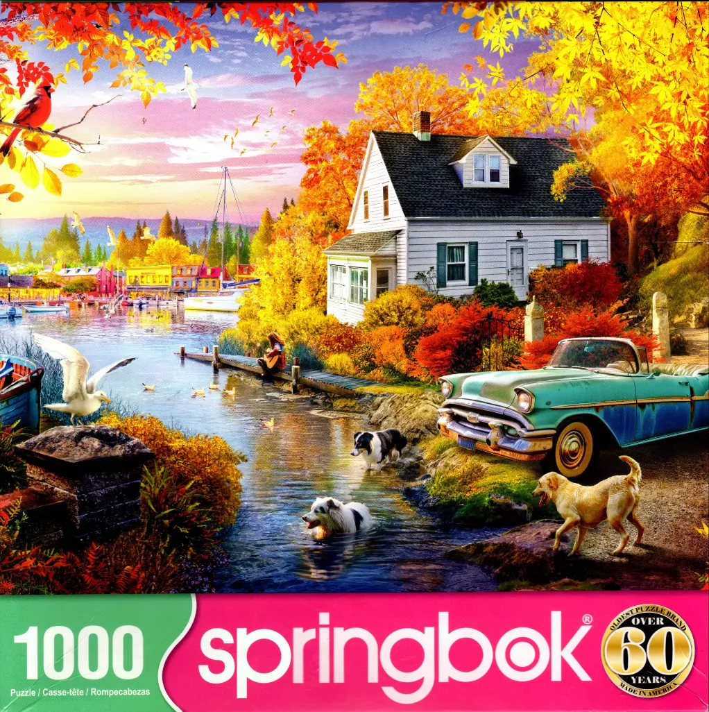 A peaceful lakeside scene in autumn with a white cottage, a vintage teal car, two dogs, and a person playing guitar.