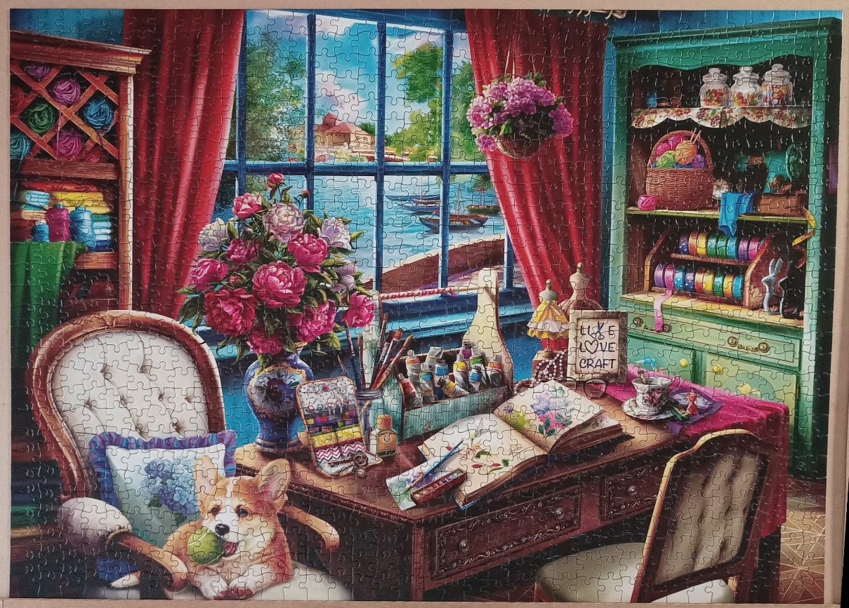 A cozy, vibrant art studio with a view of a lakeside town, featuring a corgi sitting on a chair.