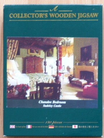 A photograph of the ornate Chandos Bedroom at Sudeley Castle, featuring a large four-poster bed and a fireplace.