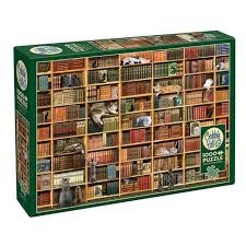 Cats hiding and sleeping among books on tall, multi-level library shelves.