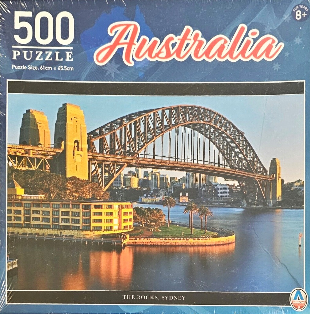 The Sydney Harbour Bridge at sunset with a waterfront building in the foreground in Sydney, Australia.