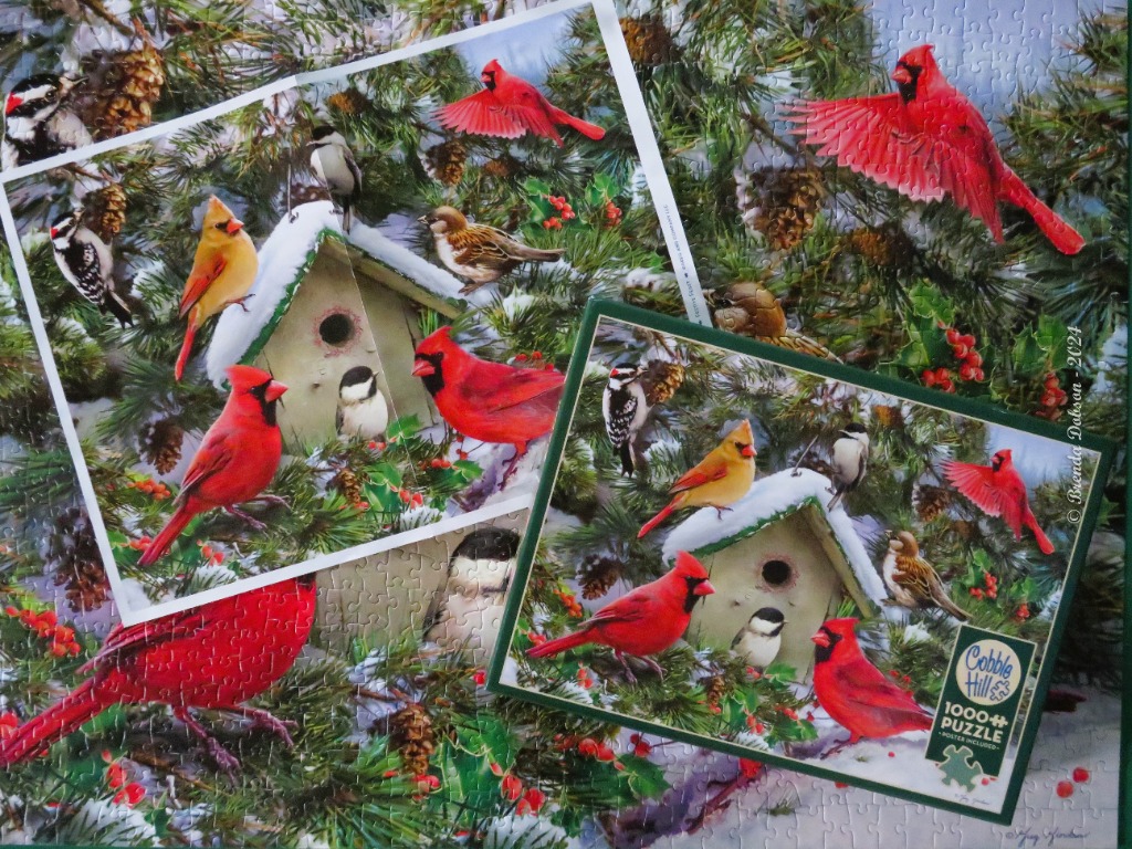 A winter scene featuring various birds perched around a snow-dusted wooden birdhouse in evergreen branches.