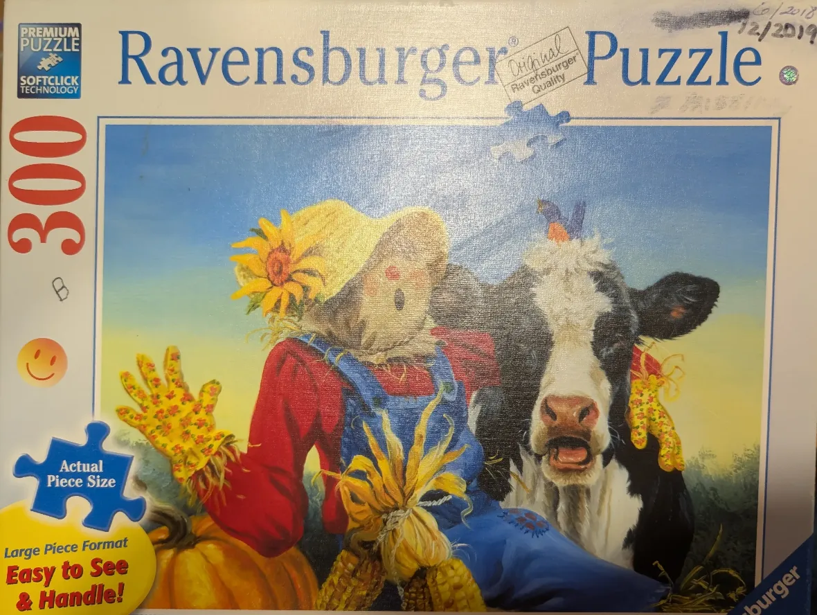 An illustration of a friendly scarecrow and a cow standing together in a farm field on a sunny day.