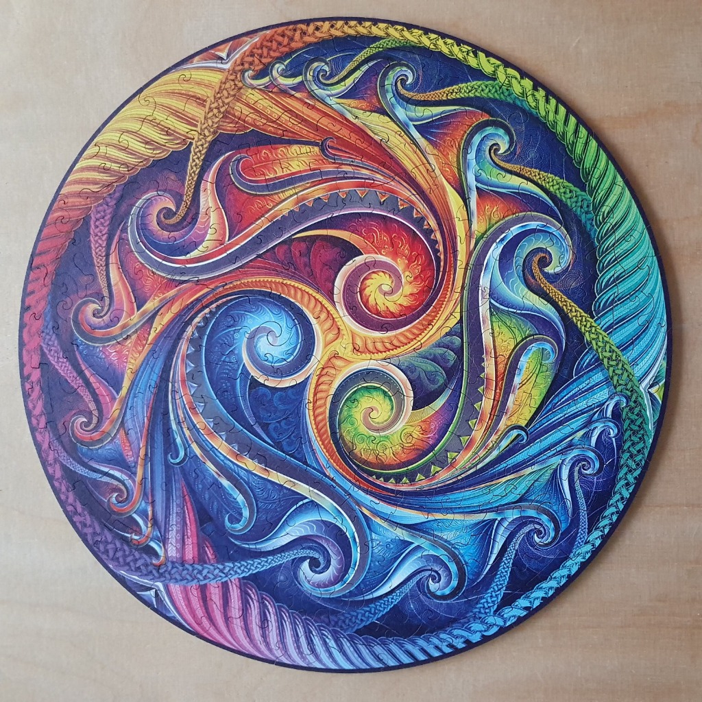 Circular abstract art with swirling, rainbow-colored fractal patterns and Celtic-inspired braided borders.