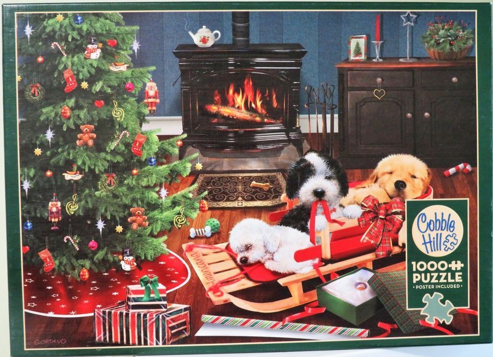 Three puppies relaxing on a wooden sled beside a decorated Christmas tree and fireplace.