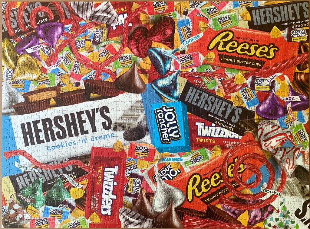 A vibrant collage of various popular chocolate bars, candies, and sweets.