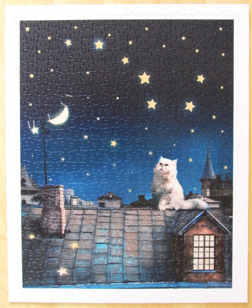 A white fluffy cat sits on a dark rooftop under a vibrant starry night sky.