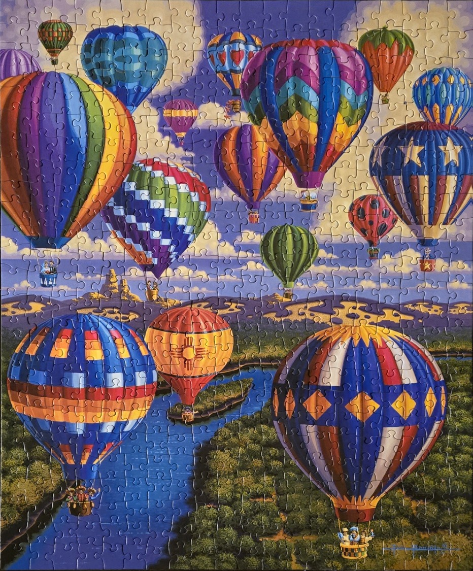 Vibrant hot air balloons floating over a winding river and forested landscape