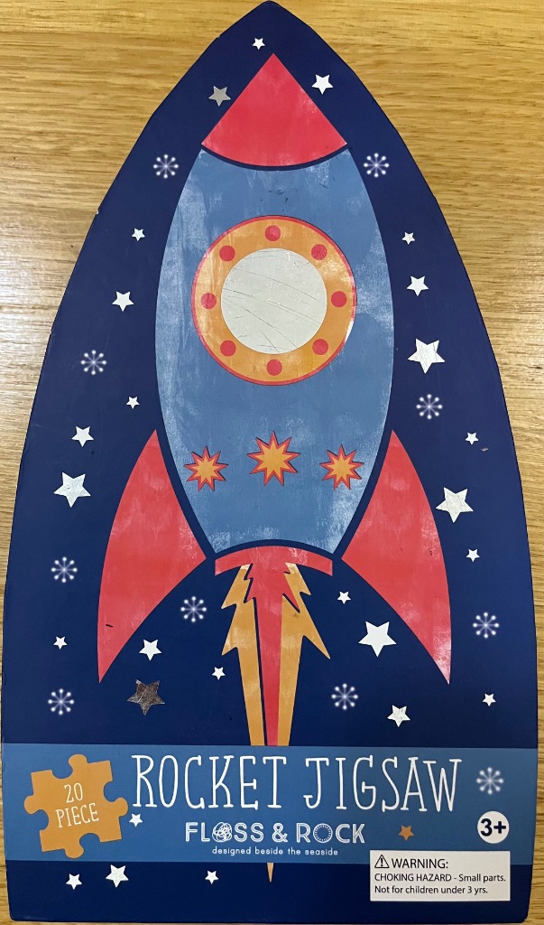 A whimsical illustration of a red and blue rocket ship surrounded by stars on a dark blue background.