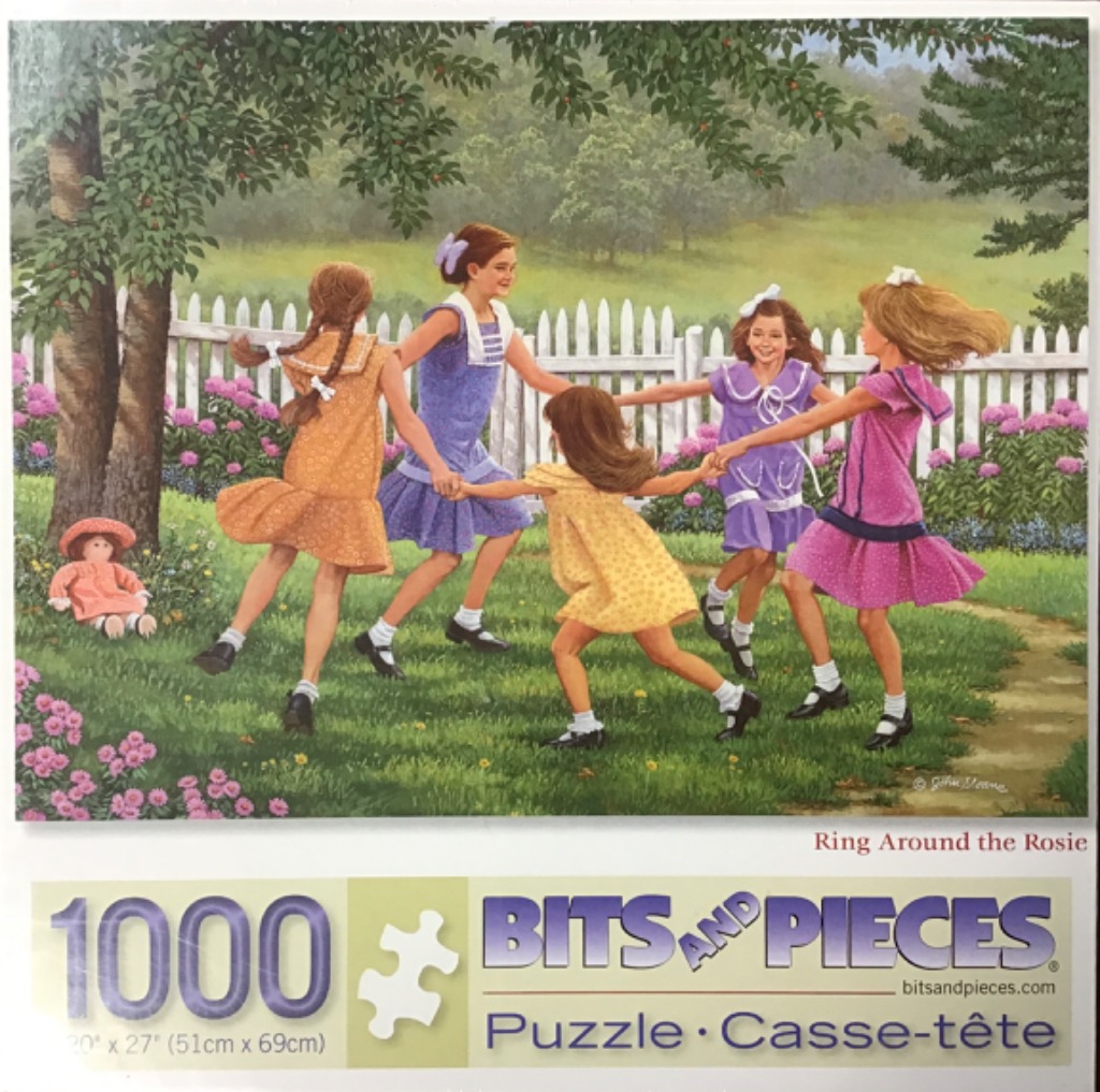 Five young girls holding hands and dancing in a circle in a grassy garden