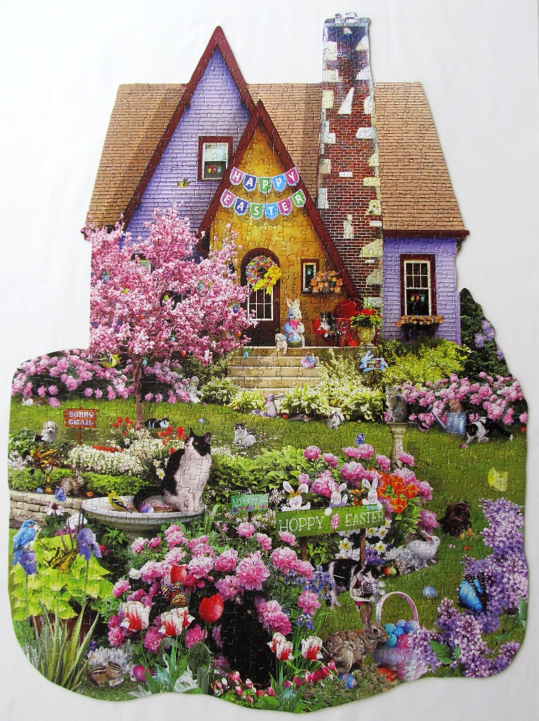 A whimsical illustration of an Easter-themed house with cats, rabbits, and blooming flowers.