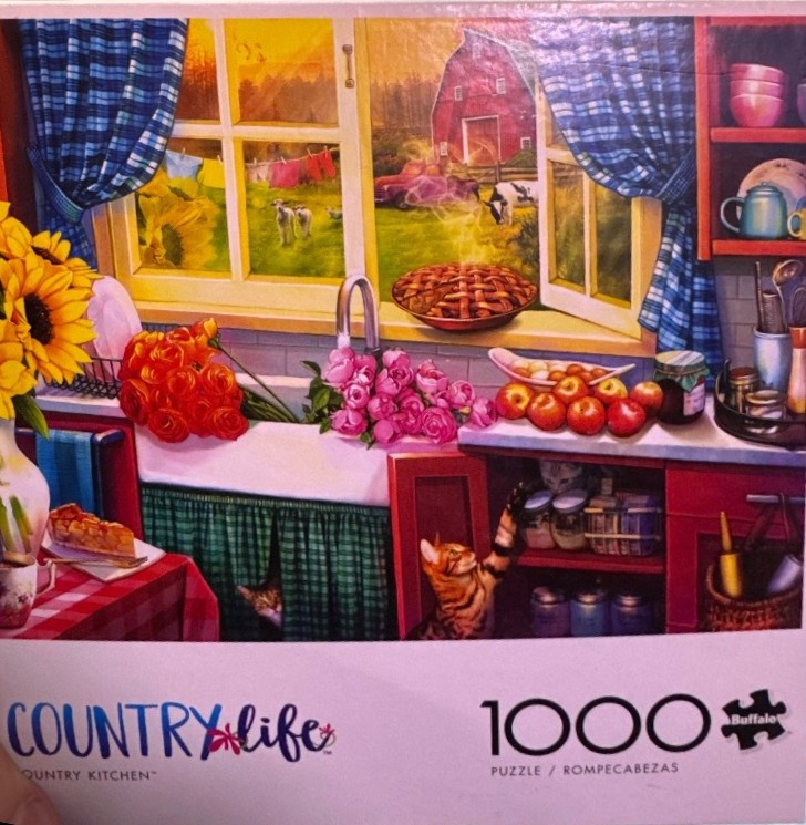 A cozy country kitchen with a farmhouse window view, sunflowers, pies, and playful cats.