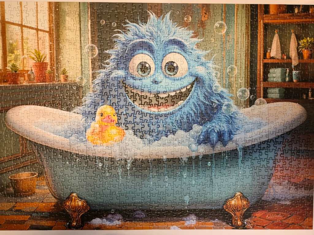 A fuzzy blue monster with large eyes smiling in a bubble-filled clawfoot bathtub with a yellow rubber duck.