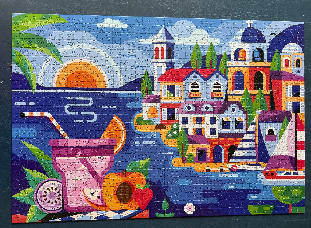A vibrant, flat-style illustration of a Mediterranean coastal village at sunset with a cocktail in the foreground.