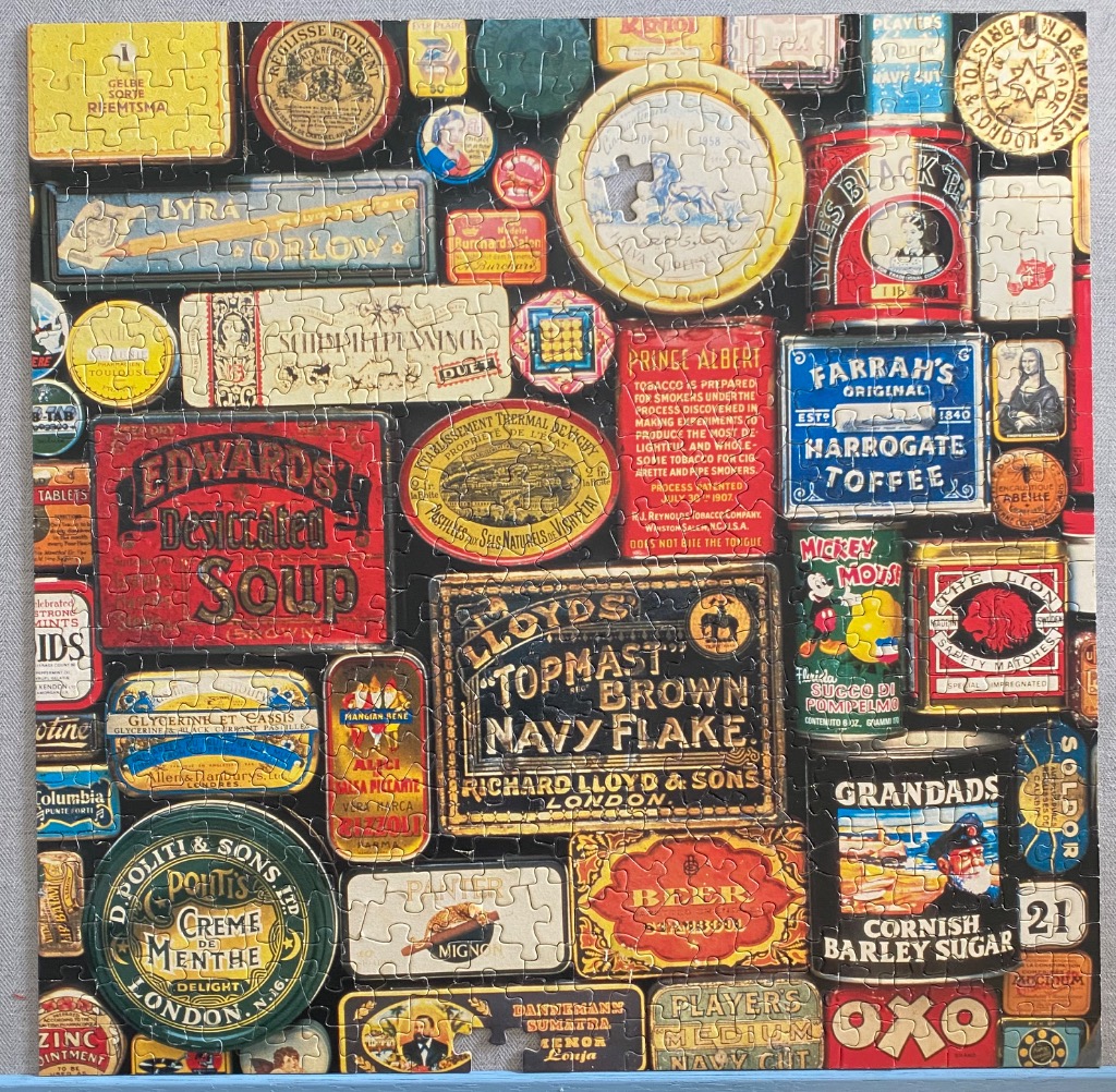 A collage of various vintage food and tobacco tins and containers.