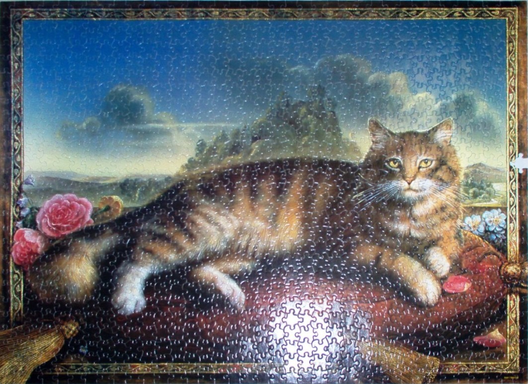 A regal brown tabby cat lying on a red velvet cushion against a landscape background in an ornate framed portrait.