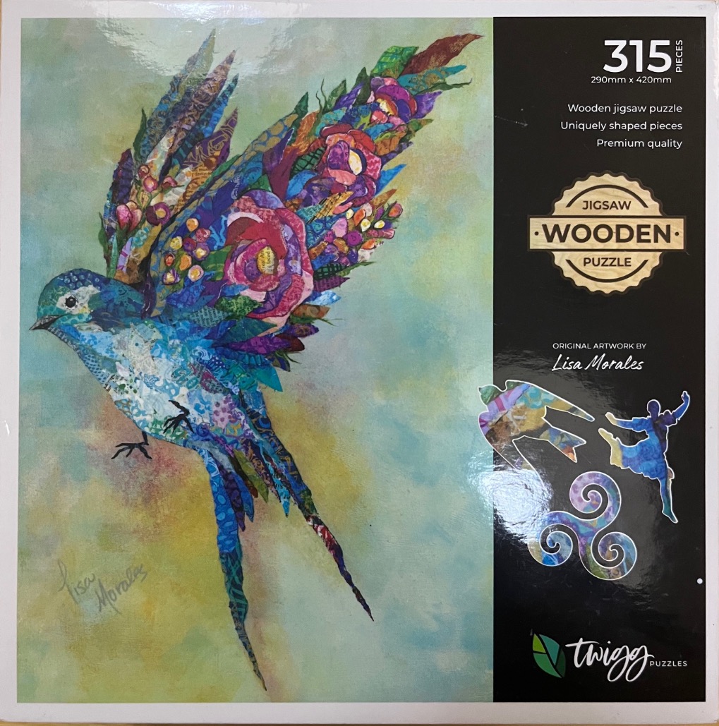 A mixed-media collage artwork of a colorful bird in flight against a soft, mottled background.