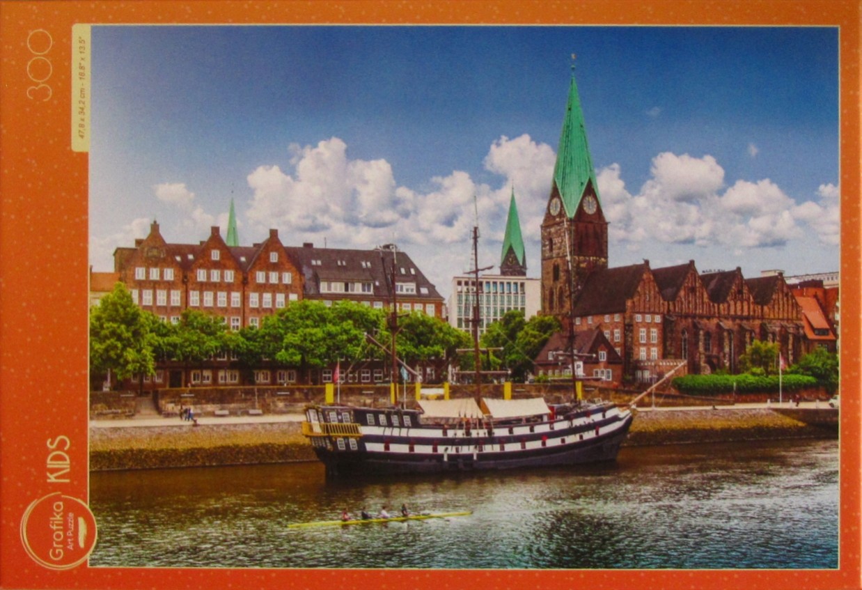 A scenic photograph of a historic European waterfront with a large sailing ship and a church featuring a green spire.