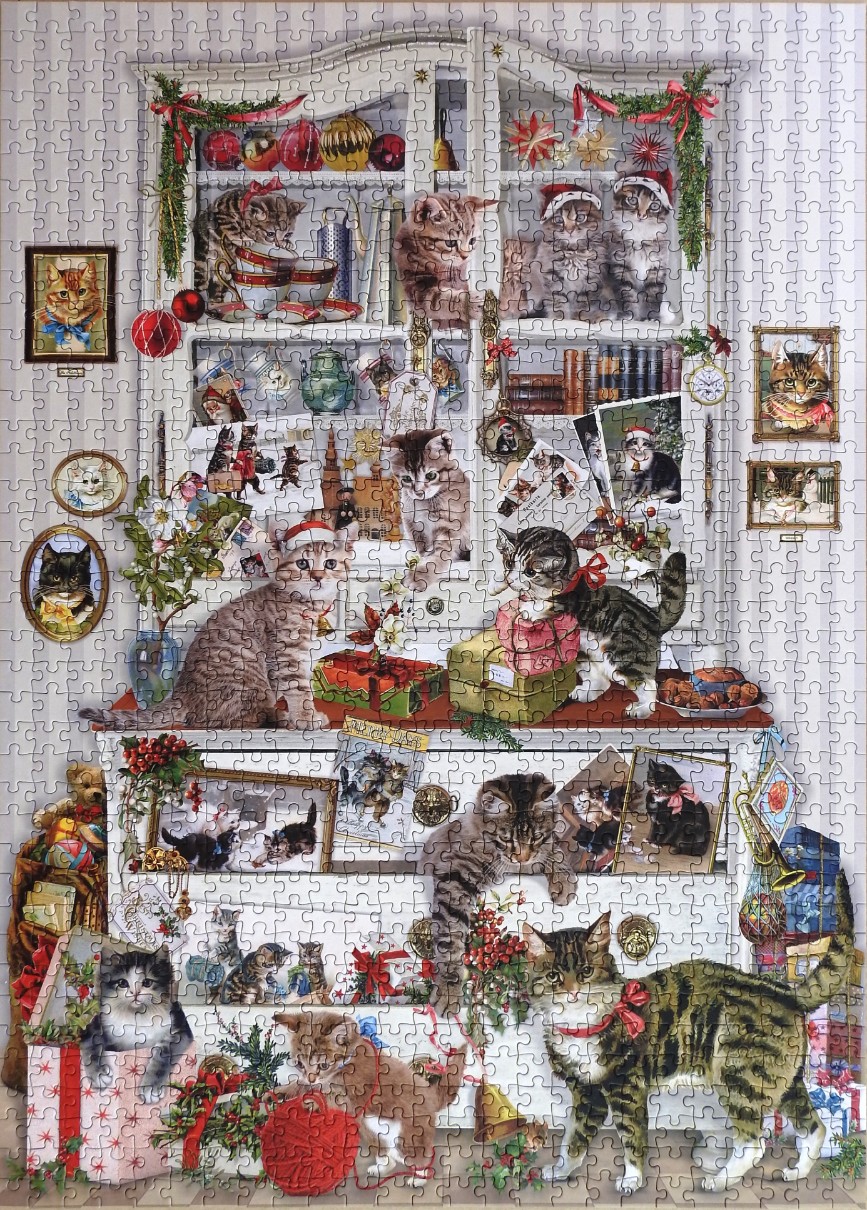 A whimsical Christmas scene featuring many kittens interacting with a hutch and holiday gifts.