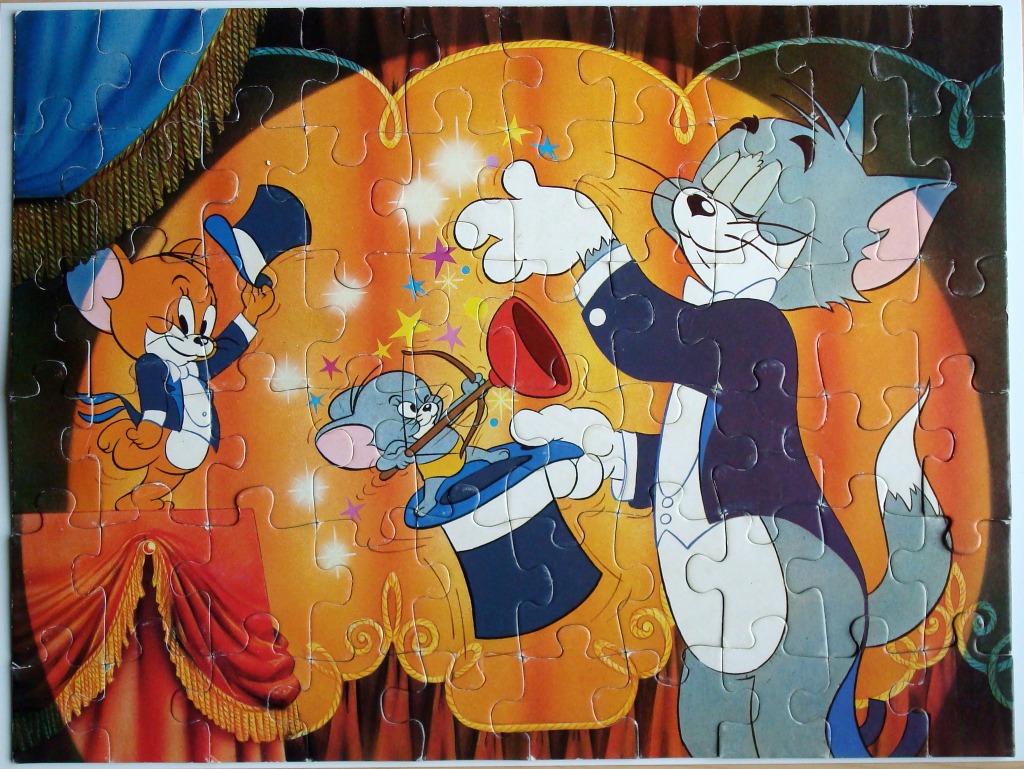 Cartoon scene featuring Tom the cat and Jerry the mouse performing a magic trick on a stage.
